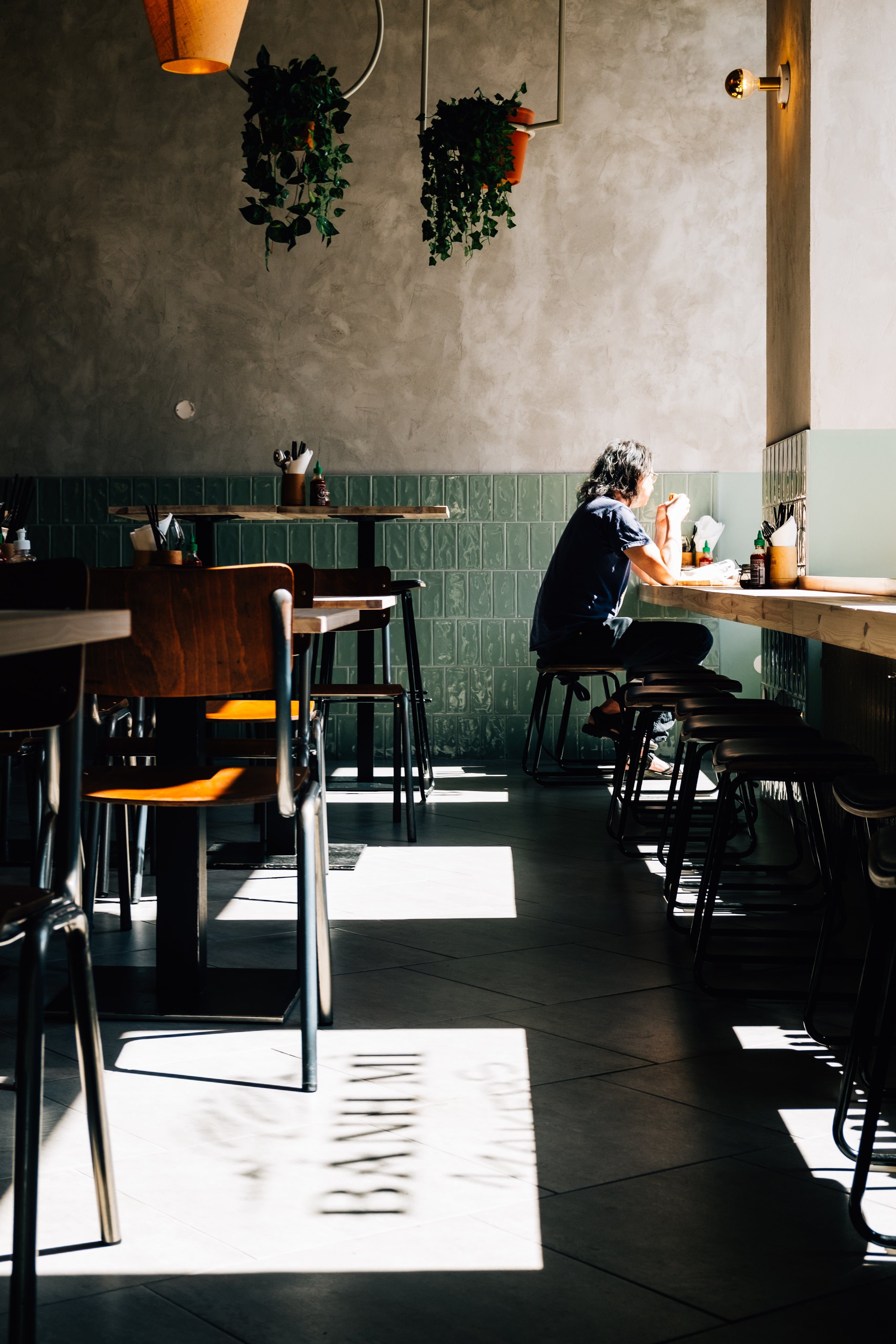 person-enjoys-lunch-alone-in-a-sunlit-restaurant.jpg